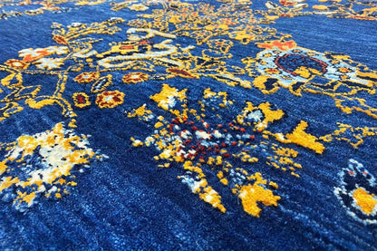 Blue Gabbeh rug with a colorful yellow ornament pattern, close-up of the pile texture