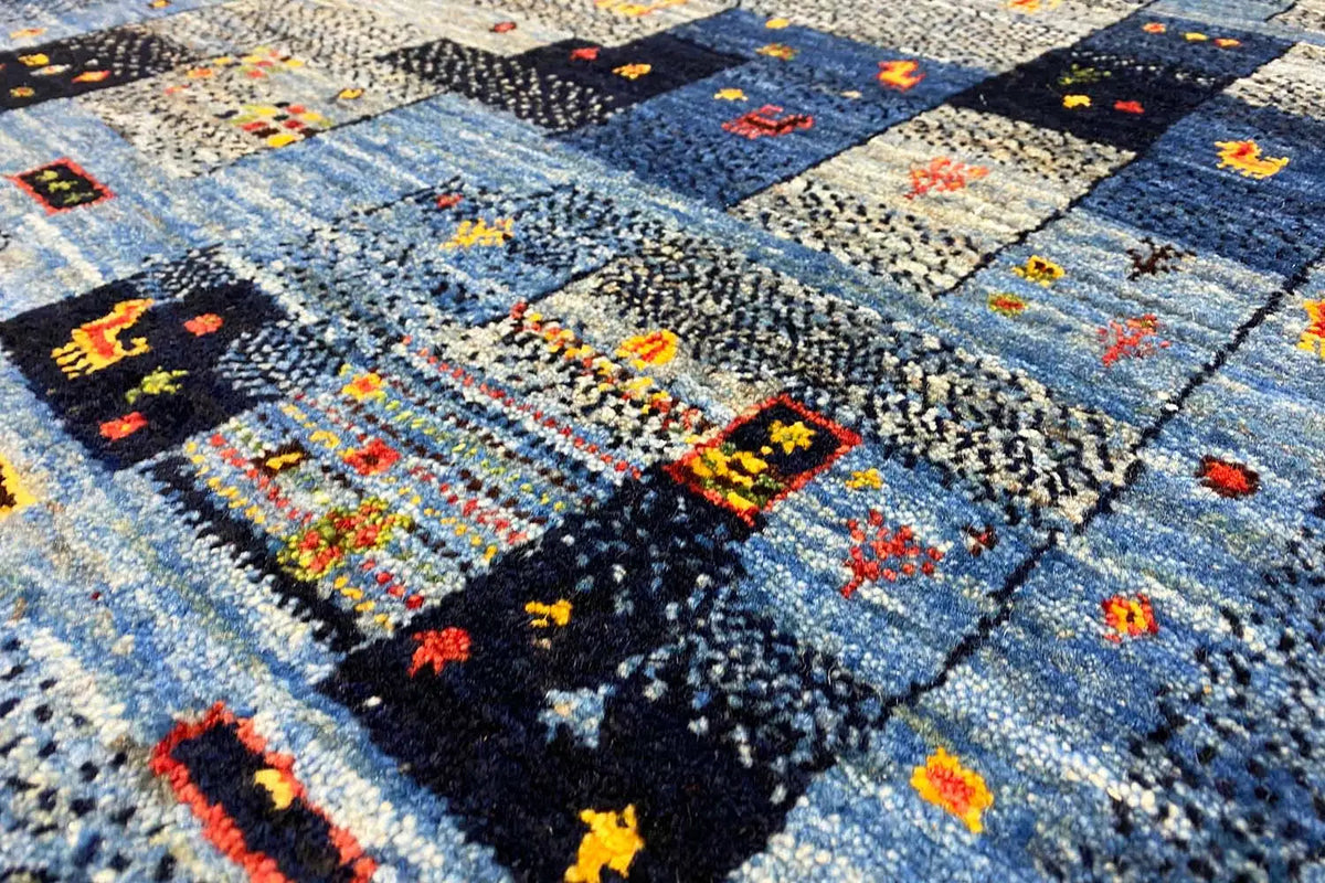 Gabbeh rug with an abstract patchwork pattern in blue and colorful accents