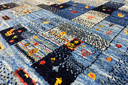 Gabbeh rug with an abstract patchwork pattern in blue and colorful accents