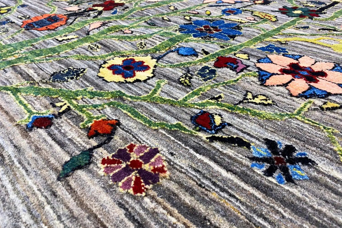 Gabbeh Lori rug with an ornamental tree motif and colorful flowers, close-up