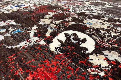 Gabbeh rug with a dark background, red pattern, and white ornaments, close-up view