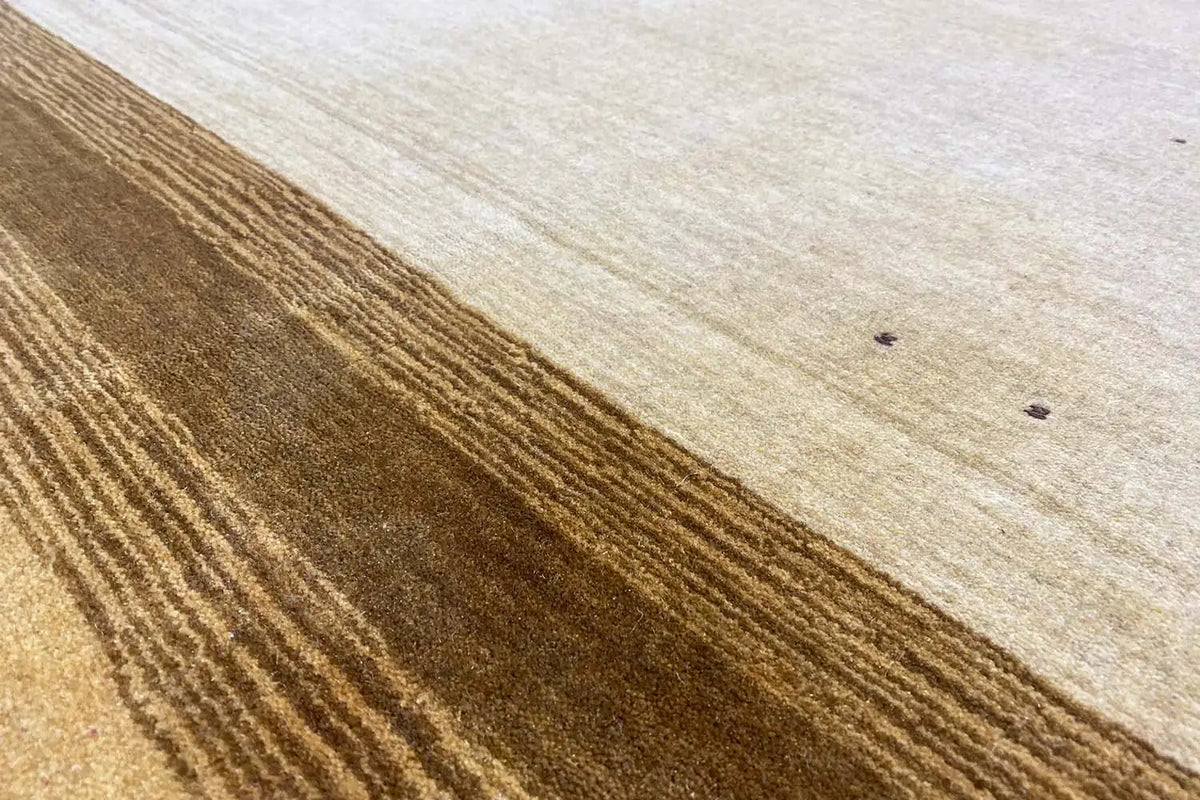Gabbeh rug, beige low pile with brown stripes, captured from the side