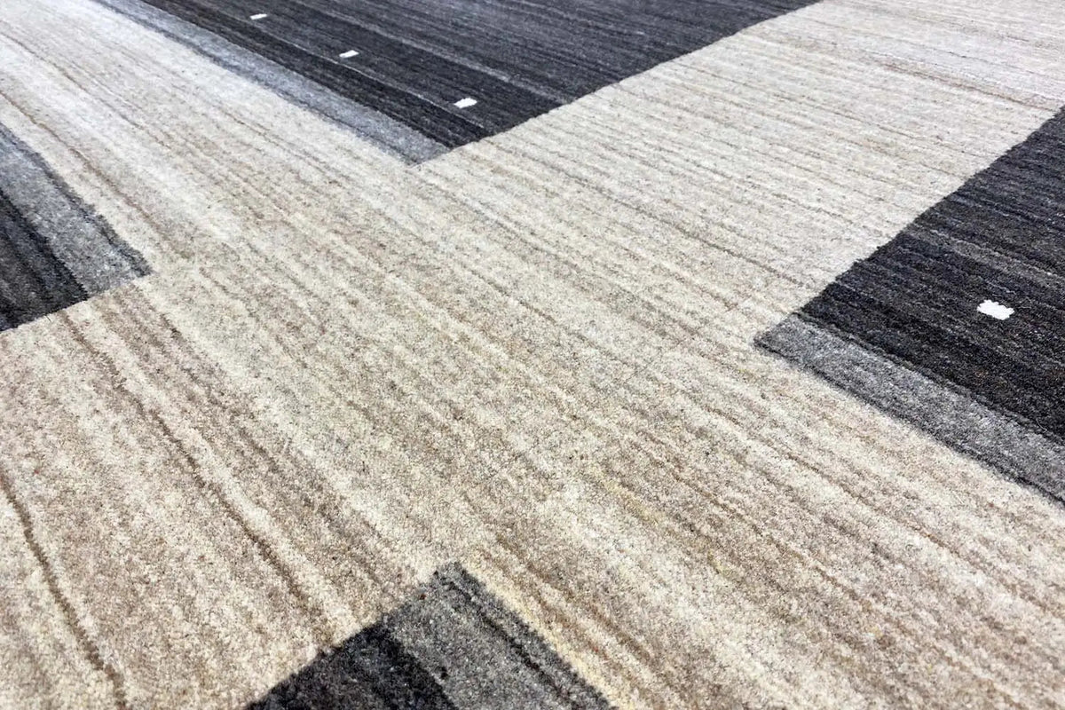Gabbeh rug with a geometric pattern: light bands and dark zones with dots