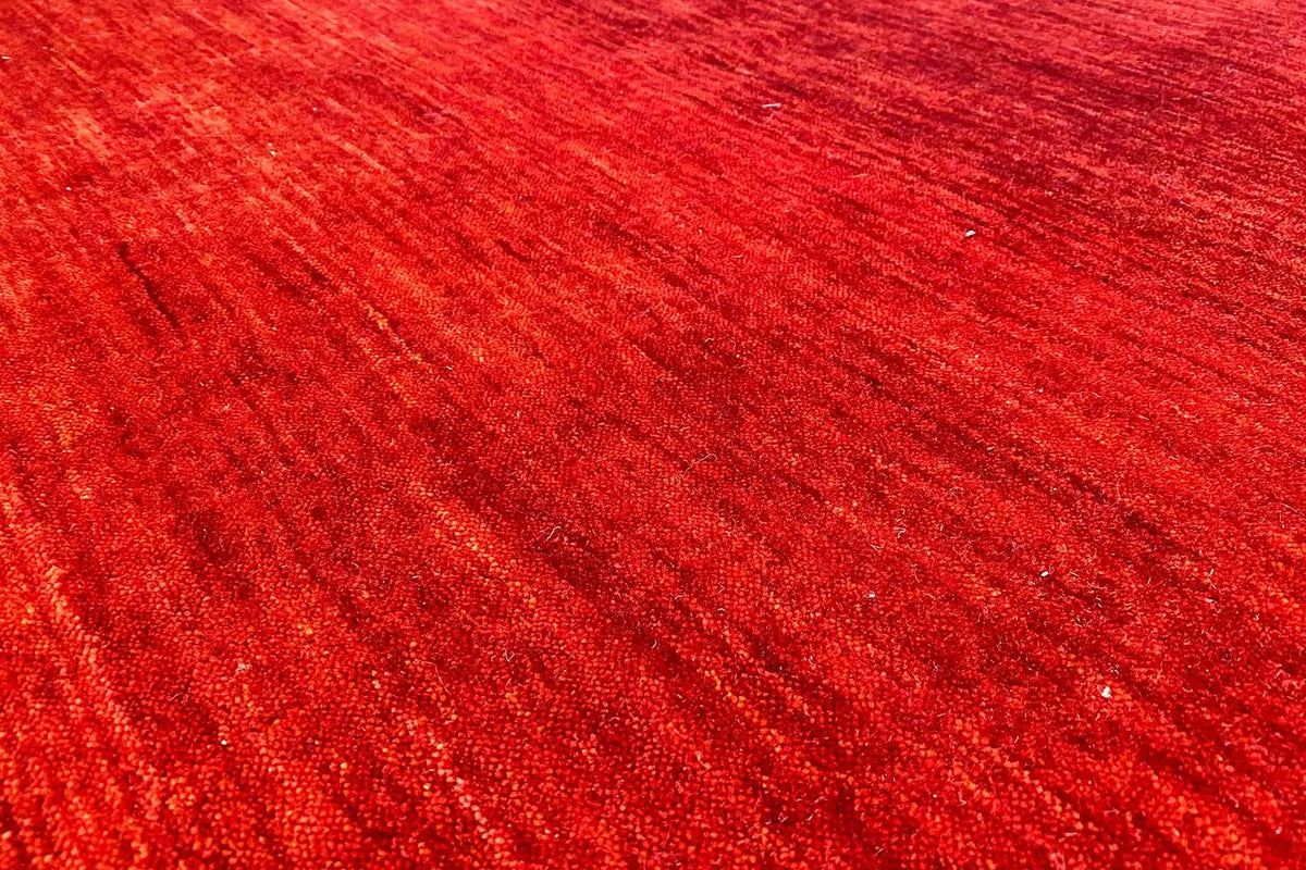 Red Gabbeh rug with a fine texture, close-up of the pile surface