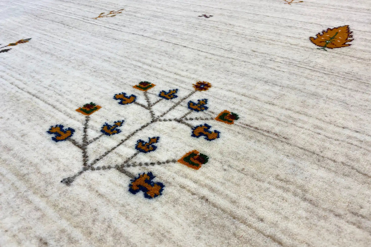 Light beige Gabbeh rug with multicolored vine pattern, close-up