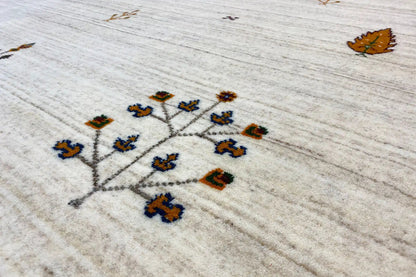 Light beige Gabbeh rug with multicolored vine pattern, close-up