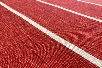 Red kilim rug, detail of the white stripes and woven texture