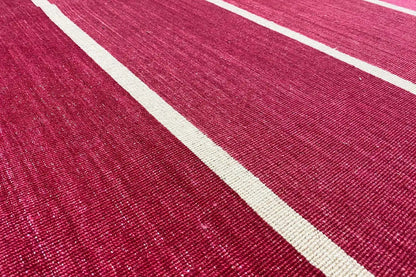 Close-up of a red kilim with beige stripes, striped woven texture
