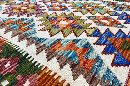 Afghan kilim (148x95 cm) close-up: multicolored patterns and fringed border