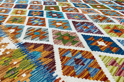 Afghan kilim with a colorful geometric pattern, close-up of the woven texture