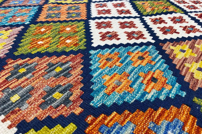 Afghan kilim with a multicolored ornamental pattern and blue central medallion, close-up