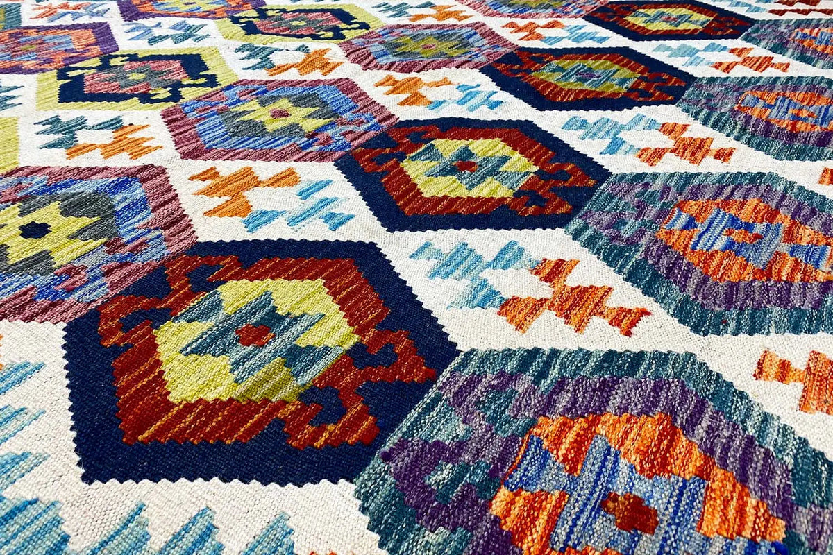 Afghan kilim rug with colorful geometric patterns and a visible weave texture