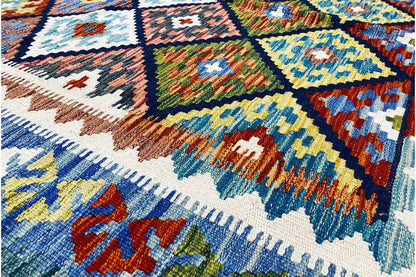 Colorful Afghan kilim with a geometric tile pattern in blue, yellow, red, and green