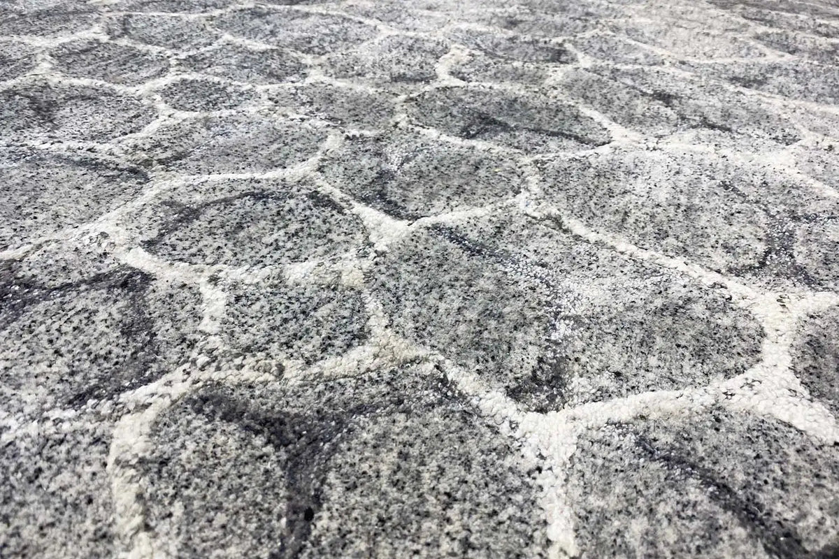 Hand-tufted gray rug with an abstract pattern and mottled pile