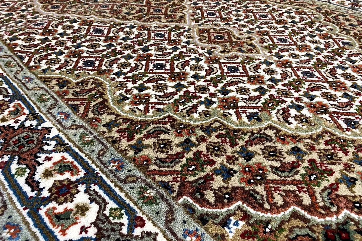 Tabriz rug with an ornate pattern, close-up of the textured surface
