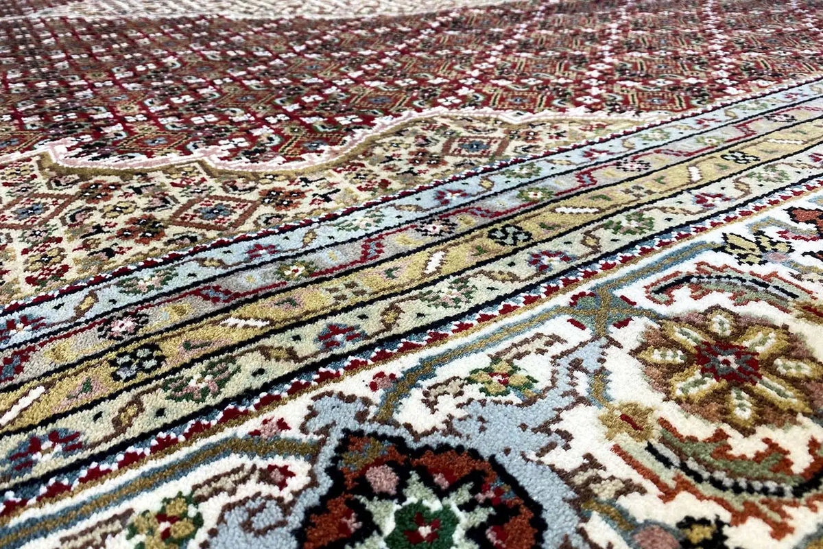 Indo Tabriz rug with border and medallion pattern, beige, red, blue