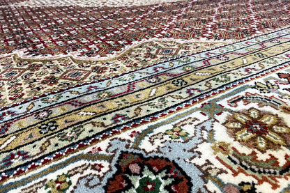 Indo Tabriz rug with border and medallion pattern, beige, red, blue