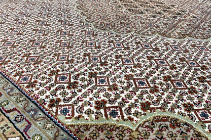 Indo Tabriz rug with multicolored pattern and border, close-up view