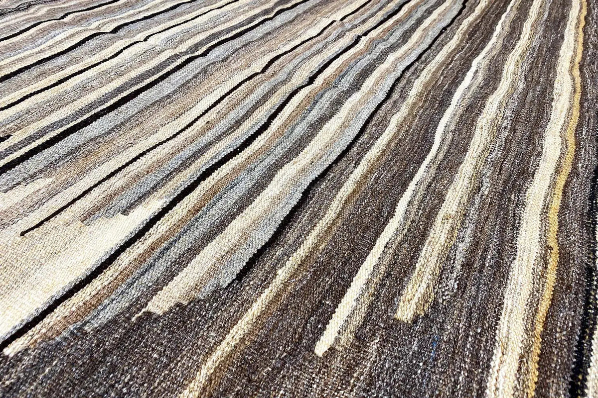 Kilim rug with a striped pattern in brown, beige, and dark gray