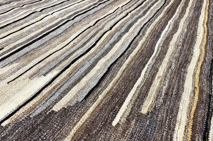 Kilim rug with a striped pattern in brown, beige, and dark gray