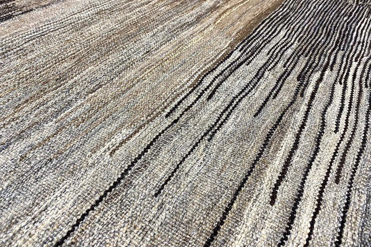 Kilim rug with light and dark gray stripes, fine woven texture.