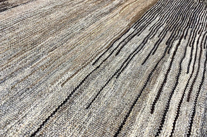Kilim rug with light and dark gray stripes, fine woven texture.