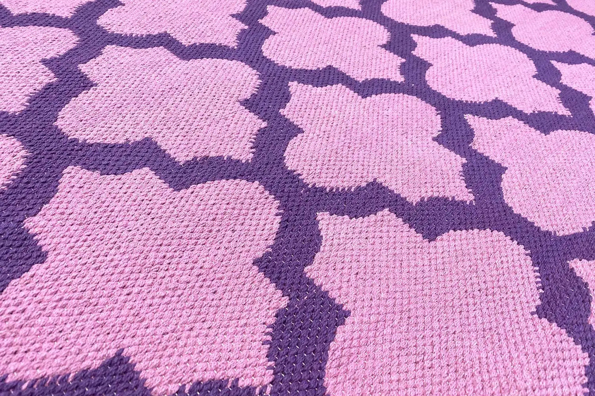 Rug with purple and pink clover flower motifs, even flat weave