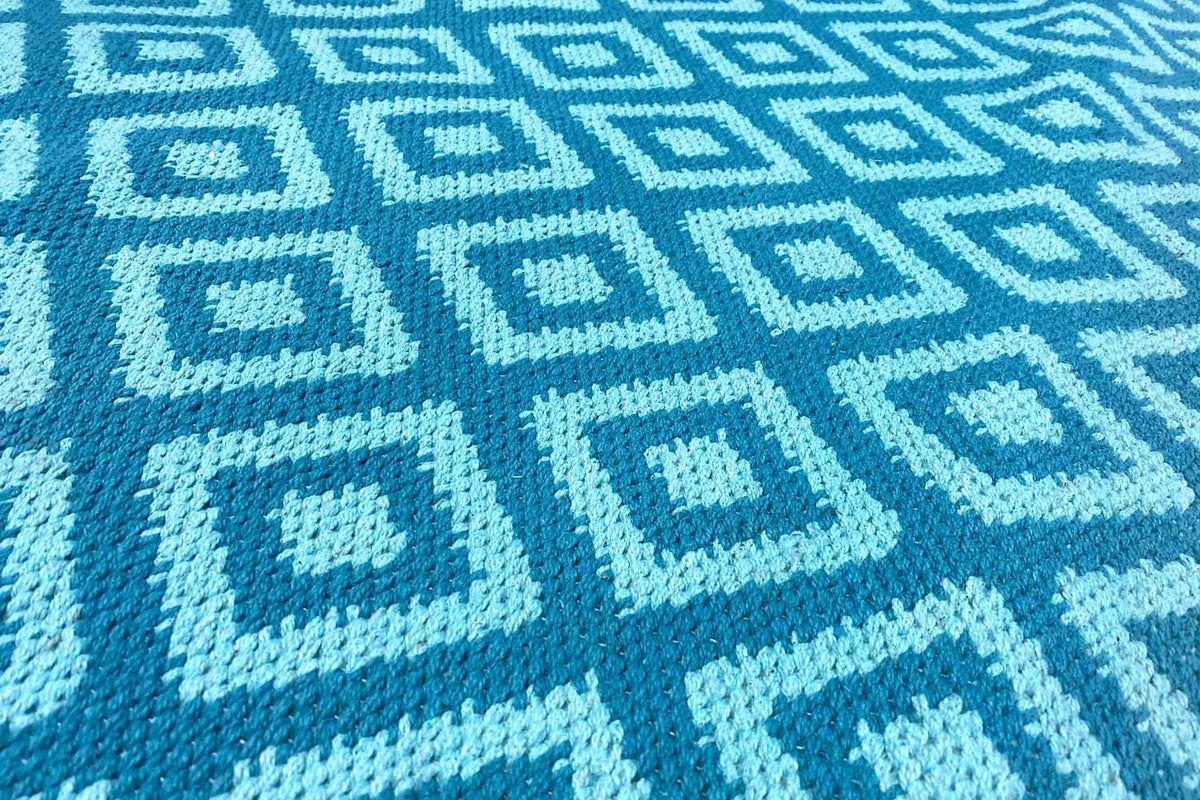 Blue kilim with a geometric tile pattern in light blue and dark blue
