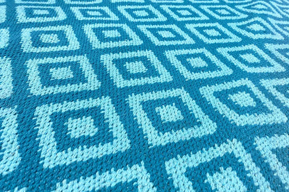Blue kilim with a geometric tile pattern in light blue and dark blue
