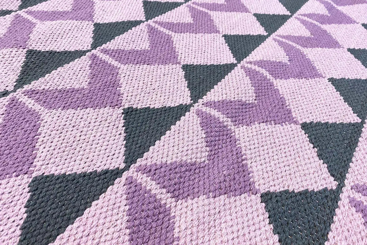 Carpet in a purple-and-white design with geometric squares and triangles