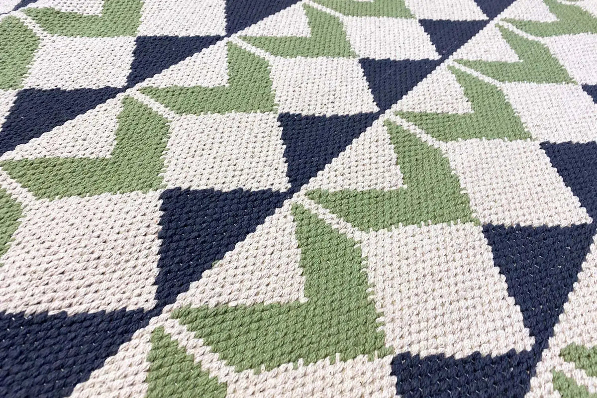 Flat-woven kilim rug with a geometric cube pattern in green, blue, and white
