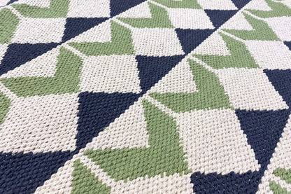 Flat-woven kilim rug with a geometric cube pattern in green, blue, and white
