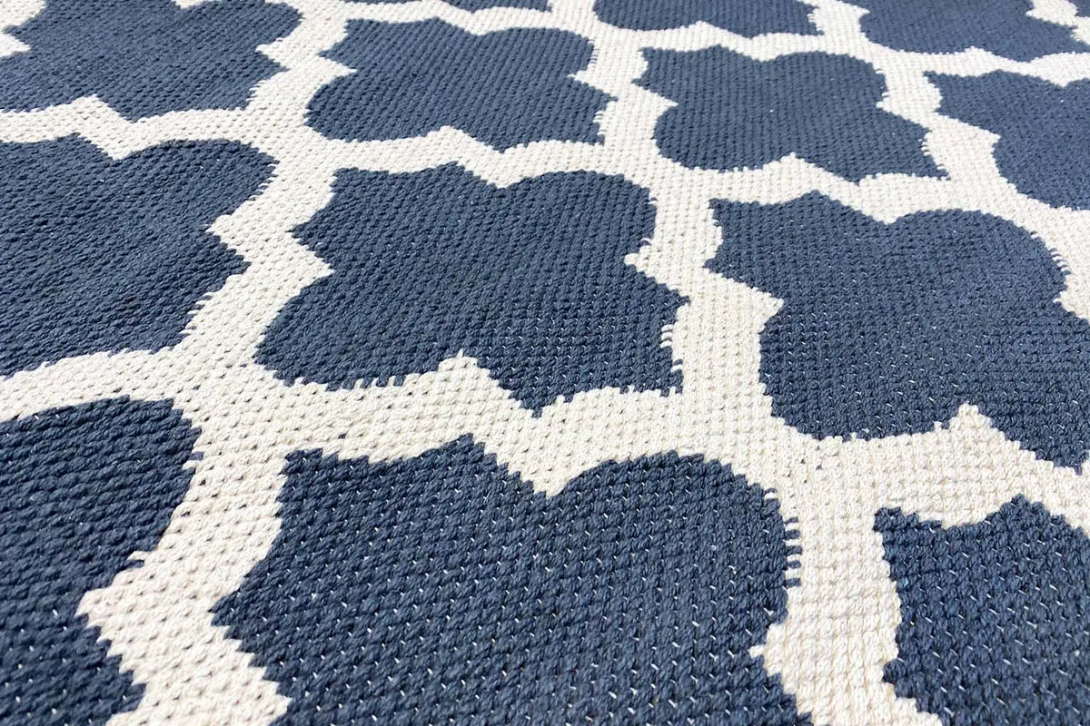 Kilim rug with a dark blue background and white diamond lattice pattern, detailed texture
