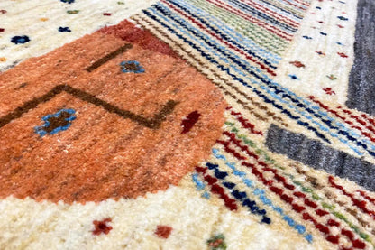Close-up of a Gabbeh-Lori rug: orange-brown motif, colorful stripes, and dotted ornaments