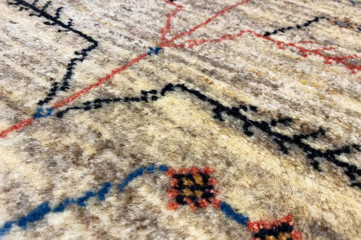Gabbeh-Lori rug, close-up with a geometric pattern in blue, red, and black
