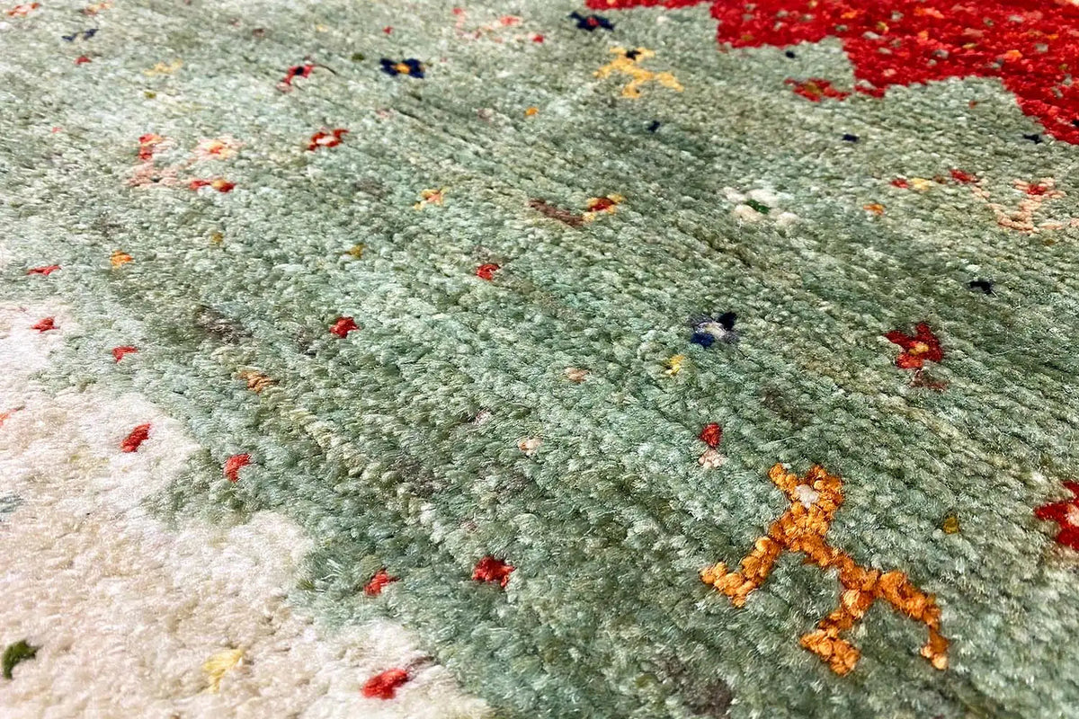 Lori gabbeh rug with green pile and colorful dot patterns, detail view.
