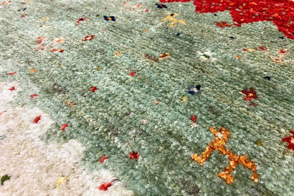 Lori gabbeh rug with green pile and colorful dot patterns, detail view.