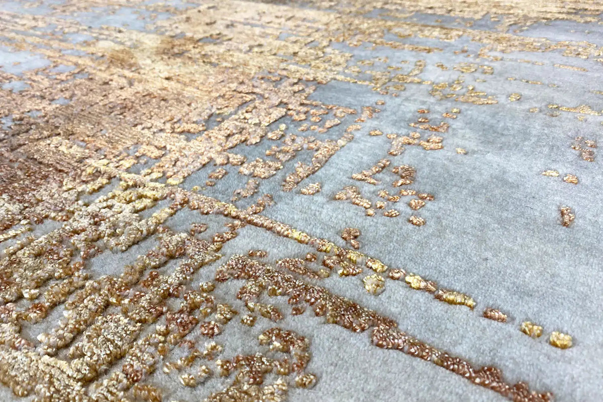 Carpet detail with gold, brown, and beige textures on light gray