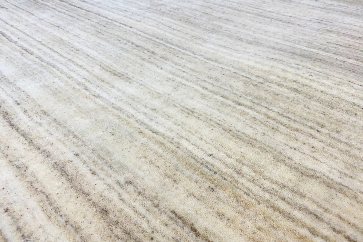 Close-up: beige Gabbeh loom rug with fine lines in the weave pattern