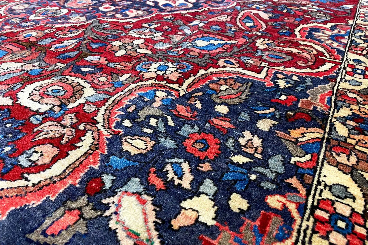 Floral rug 316x216 cm with a red, blue, and cream ornamental pattern