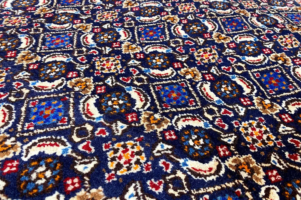 Moud rug with a blue, red, and beige ornamental pattern in close-up