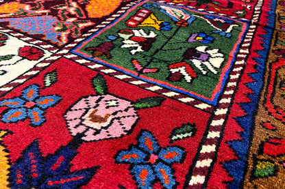 Bakhtiari carpet detail view: red, blue, green and white, with border