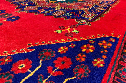 Carpet surface with floral pattern: red area, dark blue field, and colorful accents