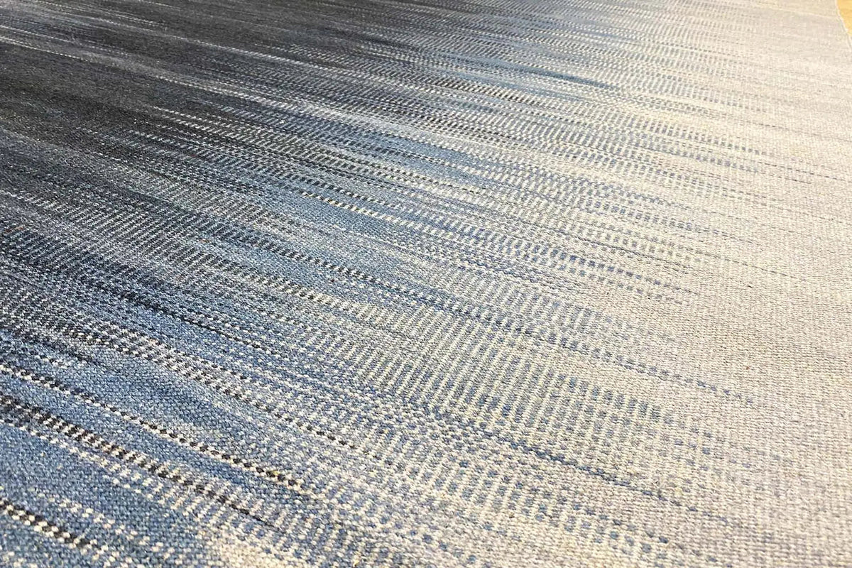 Blue kilim dhurrie rug with fine stripes and a compact weave, detail view