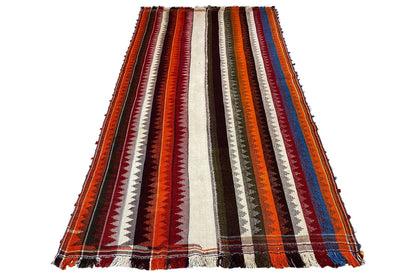 Jajim rug in a standing view: striped pattern with fringes and vertical zones