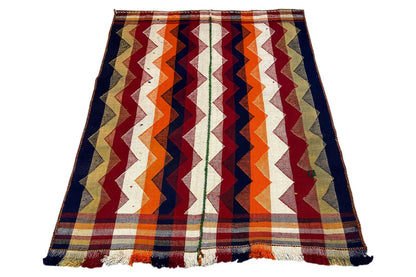 Rectangular jajim rug with a zigzag pattern in dark blue, orange, burgundy, and beige