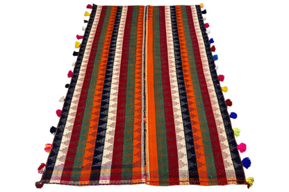 Jajim rug: vertical stripes in orange, green, red, and blue with colorful tassels.