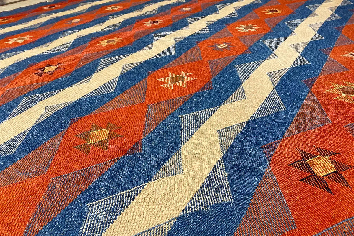 Jajim Exclusive rug 191x254 cm: close-up of the texture with blue, red, and cream-colored patterns