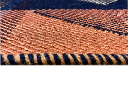Jajim exclusive rug: close-up of the woven texture and fringes in orange and blue