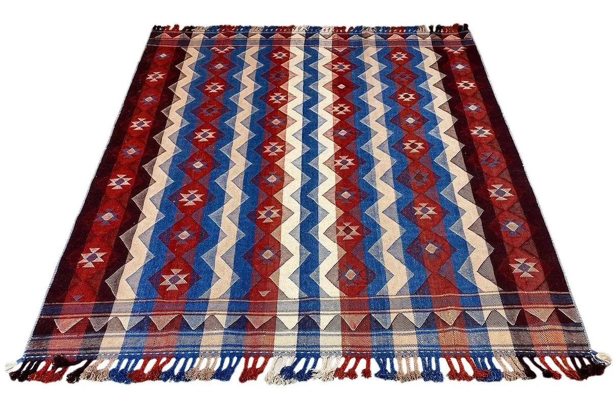 Jajim rug with a broad zigzag stripe pattern in red, blue, and cream, tassels